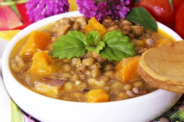 Lentil casserole with wooden spoon — Stock Photo, Image