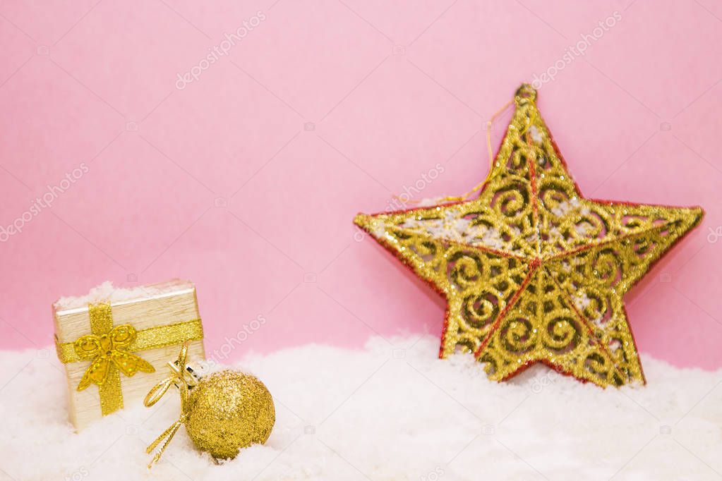 Christmas decorations and gift box on snow