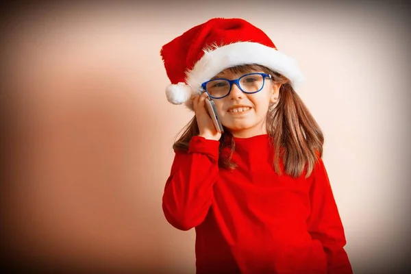 Mała Dziewczynka Kapelusz Santa Claus Rozmowy Jej Telefon Komórkowy — Zdjęcie stockowe