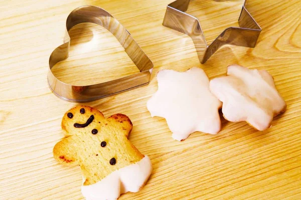 Christmas cookie molds on wooden table and christmas cookies