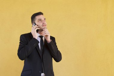 Adam düşünme ve cep telefonu ile konuşurken takım elbise ile