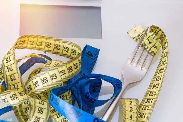 Diet and slimming concept. weighing scale and metric tape