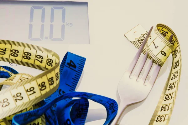 Diet and slimming concept. weighing scale and metric tape