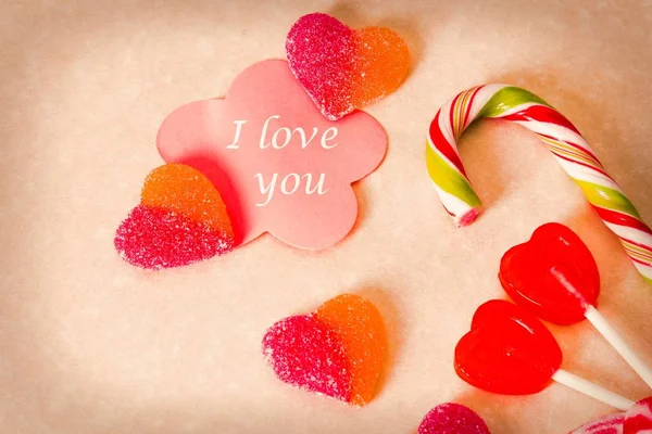 valentines greeting with heart candies and lollipops