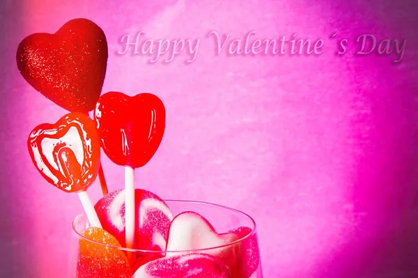 valentines greeting card with candies and heart lollipops
