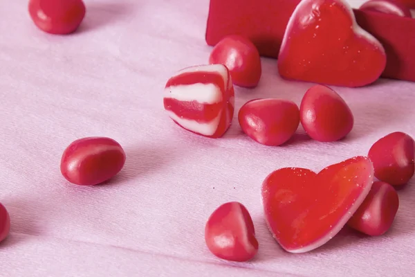 gift box with heart candies on pink background