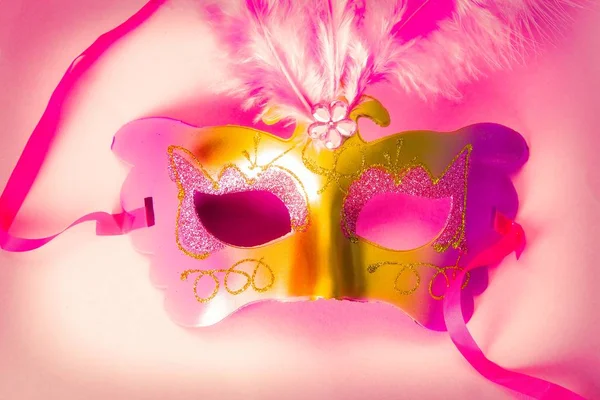 Carnival party. carnival mask on pink background