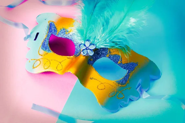 Carnival party. carnival mask on pink and blue background