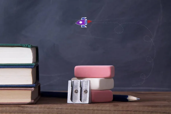 books, rubber, pencil sharpener and drawing, back to school concept