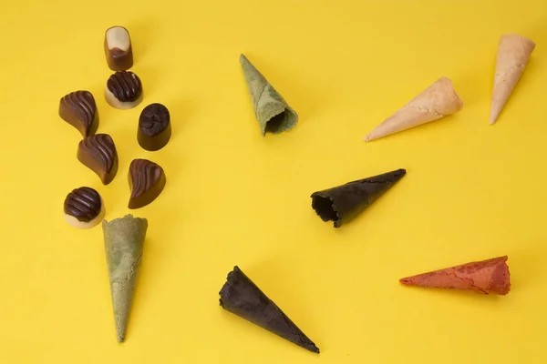 Ice Cream Cones Chocolates Yellow Background — Stock Photo, Image