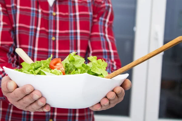 man holding salad boll, diet and health concept