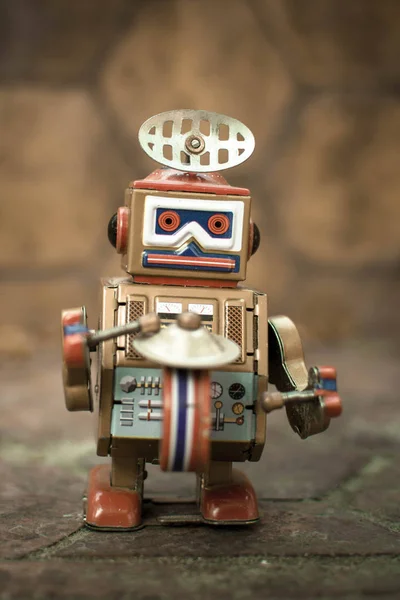 Old robot toy, vintage color style, vintage tone background.