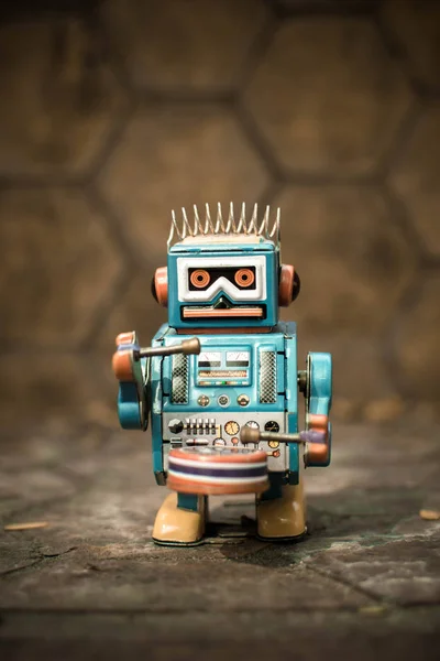 Old robot toy, vintage color style, vintage tone background.