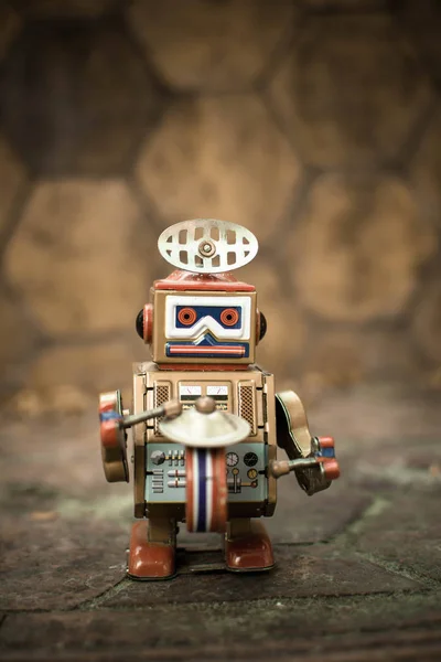 Old robot toy, vintage color style, vintage tone background.