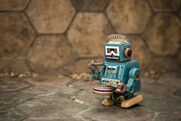 Old robot toy, vintage color style, vintage tone background.