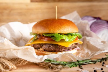 Peynirli domatesli hamburger, salata ve pirzola.