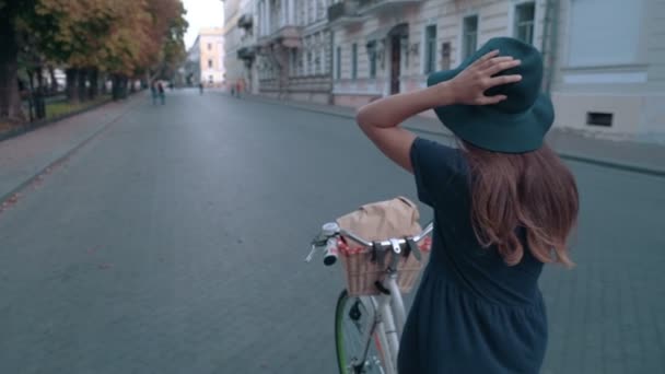 Mujer montando bicicleta vintage en la ciudad — Vídeos de Stock