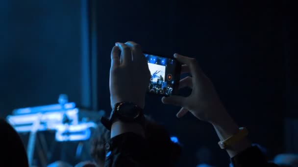 Human making video of concert — Stock Video