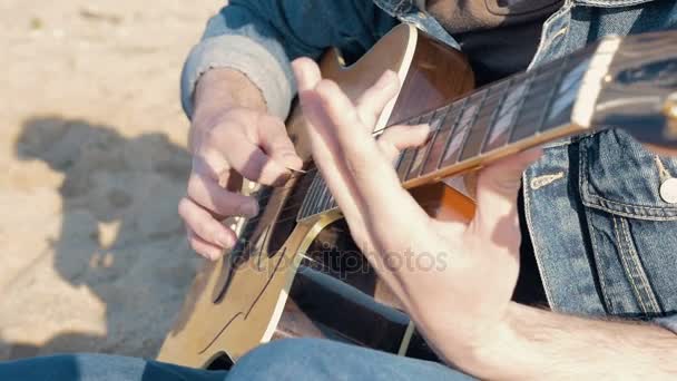 Hombre tocando la guitarra durante la puesta del sol — Vídeo de stock