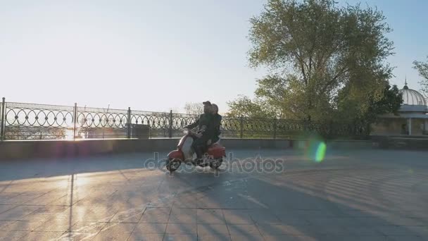 Paar bromfiets rijden bij zonsondergang — Stockvideo