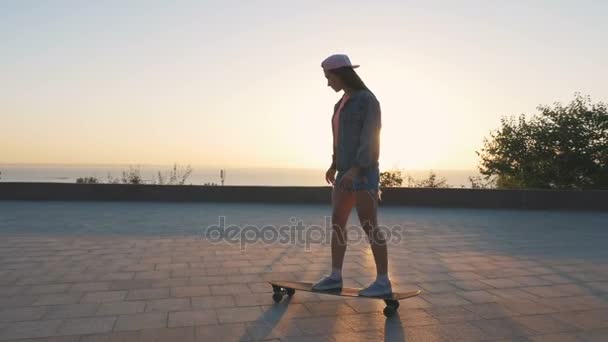 Femme chevauchant longboard au parc — Video