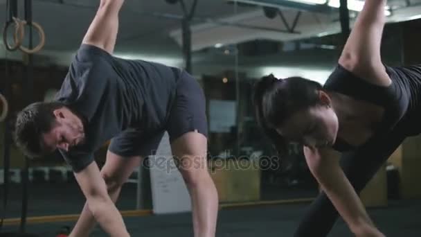 Par gör övningar i gymmet — Stockvideo