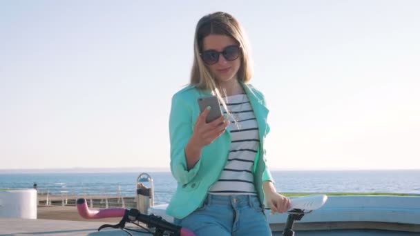 Frau benutzt Handy am Meeresufer — Stockvideo