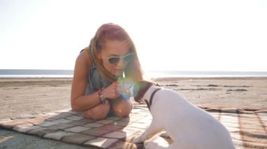 young woman playing with puppy