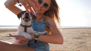 young woman playing with puppy
