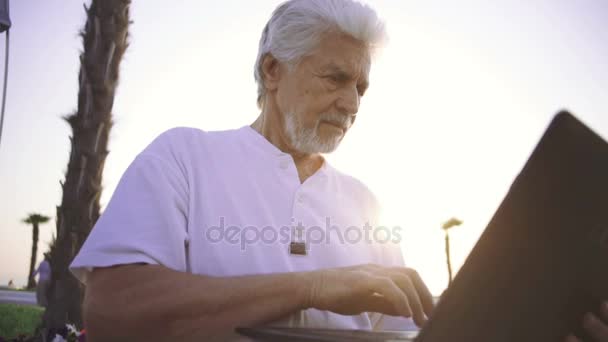 Senior man met laptop — Stockvideo