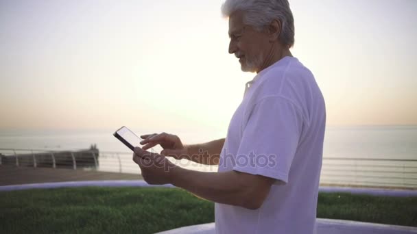 Старший человек с помощью цифрового планшета — стоковое видео