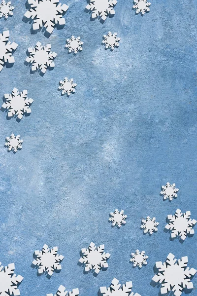 Natal e Ano Novo padrão feito de flocos de neve de madeira em um fundo azul. Natal, inverno, conceito de ano novo. Flat lay, vista superior, espaço de cópia — Fotografia de Stock