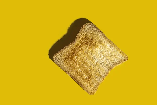 Egy arany pirítós fehér kenyérből, élénk sárga háttérrel. Fénymásolási hely — Stock Fotó