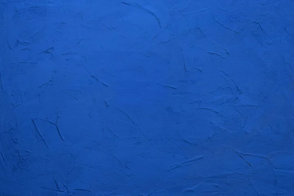 Abstraction blue background texture. Plastered painted wall