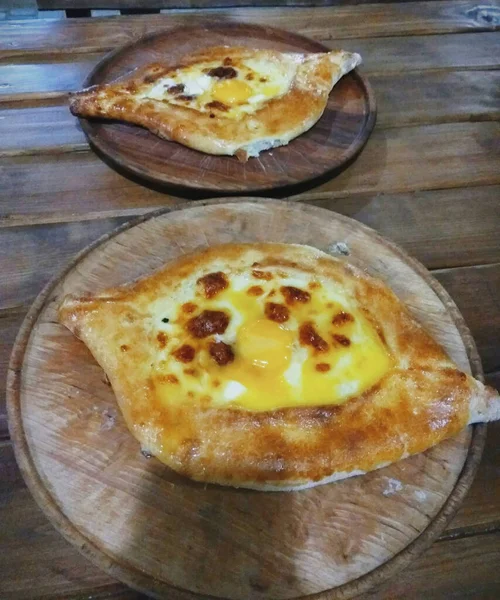 Georgian national dish khachapuri. Interesting feed.Serve on a wooden dish.