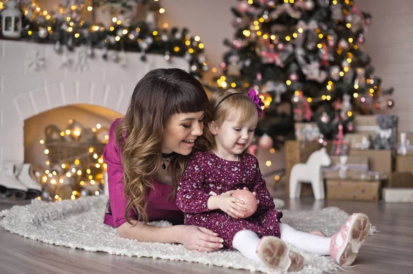 Un niño sentado alrededor del árbol de Navidad 9600 . — Foto de Stock