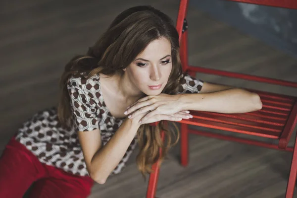 Dreamy pensive woman leaning on a chair 6946. — Stock Photo, Image