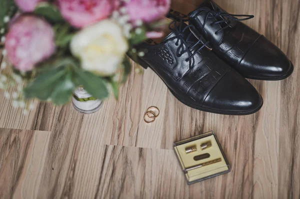 Trouwring op de verdieping omgeven door bloemen en 7427 schoenen. — Stockfoto