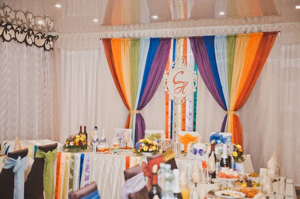 A Banquet hall decorated with rainbow ribbons and fabrics 768.