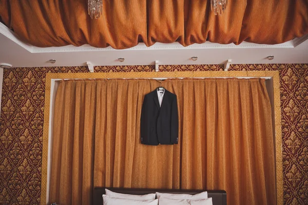 In the middle of the room hangs a suit 779. — Stock Photo, Image