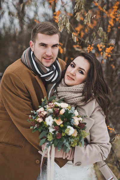 Portrait of a young couple in winter outfits among the branches — Stock Photo, Image