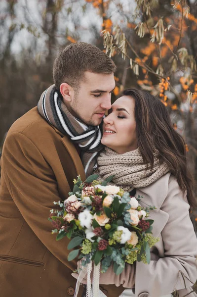 Portrait of a young couple in winter outfits among the branches — Stock Photo, Image
