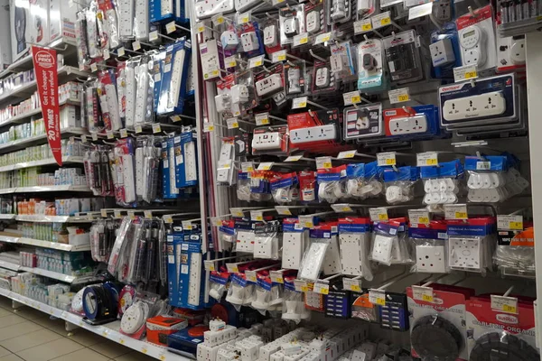 Selection of extension 3 pin plug socket wire on supermarket. Many adapter power plug or extension cord hang on the shelf. Packed ready different kinds of power strips. - Dubai UAE December 2019 — Stock Photo, Image