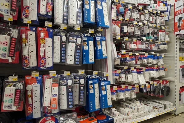 Selection of extension 3 pin plug socket wire on supermarket. Many adapter power plug or extension cord hang on the shelf. Packed ready different kinds of power strips. - Dubai UAE December 2019 — Photo