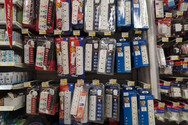 Selection of extension 3 pin plug socket wire on supermarket. Many adapter power plug or extension cord hang on the shelf. Packed ready different kinds of power strips. - Dubai UAE December 2019 — Photo