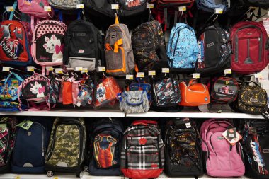 Çocuk okulu, farklı renklerde öğle yemeği çantaları, tasarımlar, şekiller ve boyutlar bir perakende mağazasında sergileniyor. New Back to School sezonu. Çeşitli üreticilerin sırt çantaları. Dubai BAE Aralık 2019