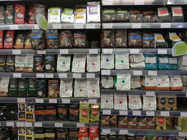 Dubai UAE - May 2019: Several packs of coffee beans and Turkish coffee on a wall of shelves. Lanes of shelves with goods products inside a supermarket in Dubai UAE. — Fotografia de Stock