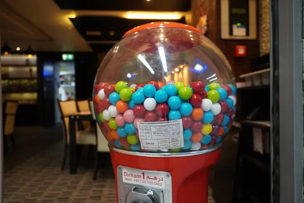 Colorful bubble gum in Coin operated gumball machine. Carousel Gumball Machine Bank kept outside a shop. - Dubai UAE January 2020 — 스톡 사진