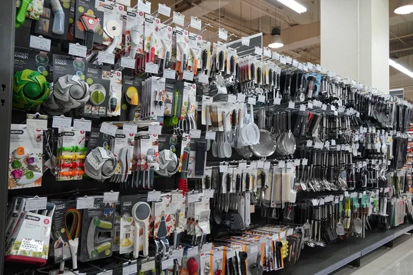 Kitchen Tools Hanging In Shop. Large Set And Variety Of Different Manufacturers On Shelves In Store. Kitchenware, Knives, Spatulas, Ladle, Tongs, Spoons, Silicon Tools. - Dubai Uae December 2019 — Stock Photo, Image