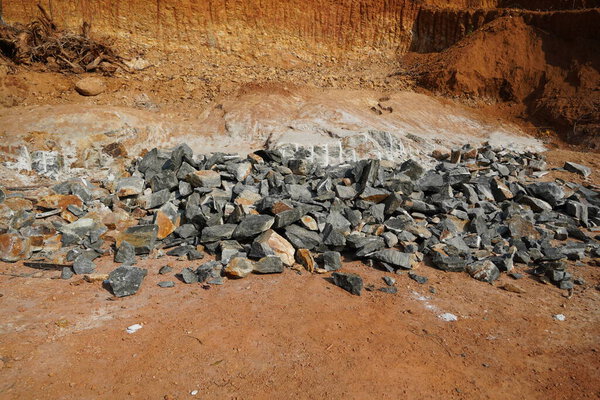 Pile Of Rocks I.E. Lithium Mining And Natural Resources Like Limestone Mining In Quarry. Natural Zeolite Rocks Are Excavated With Deforestation In Background.